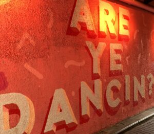 Red wall with "Are you dancing?" written on it