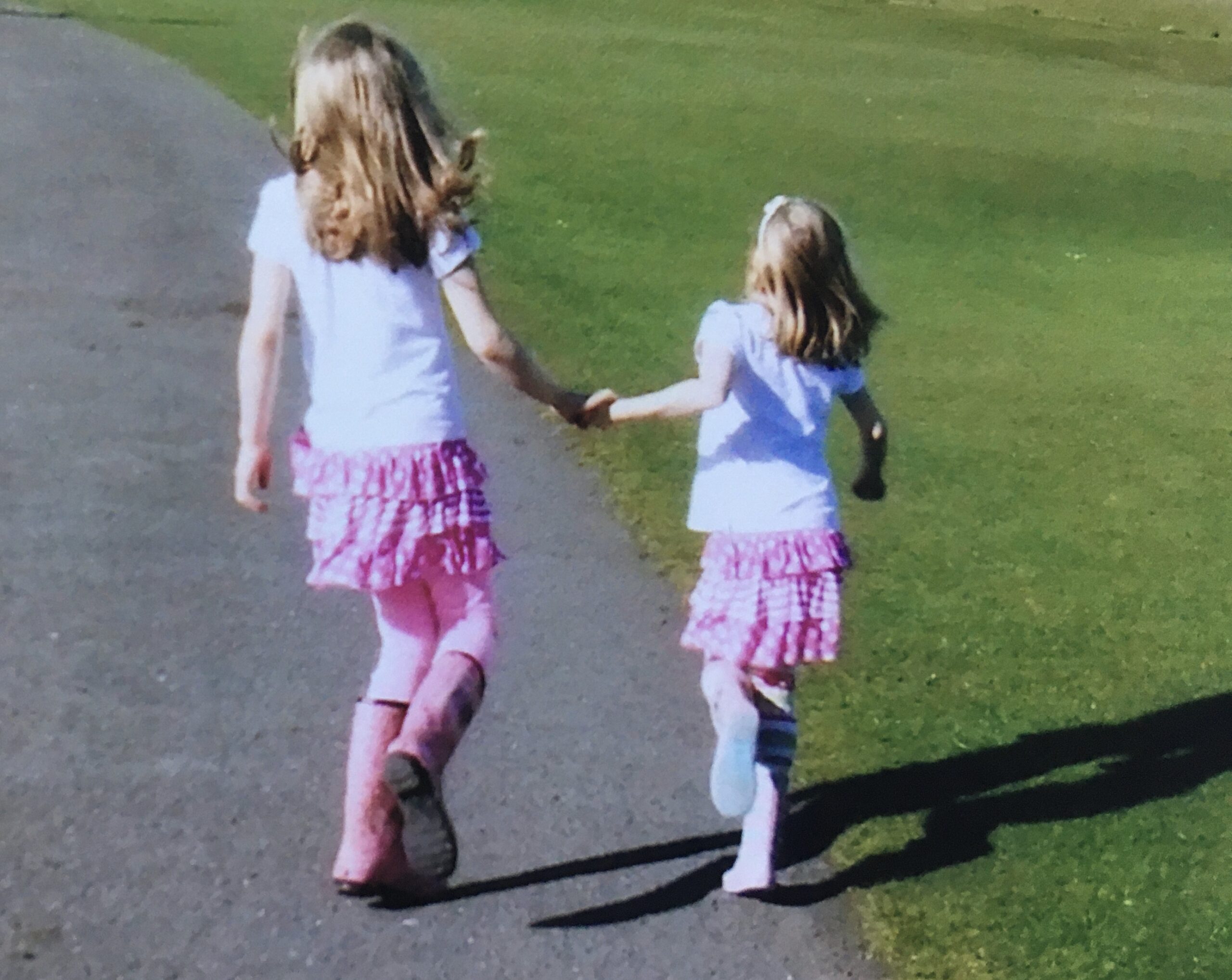 two young girls holding hands
